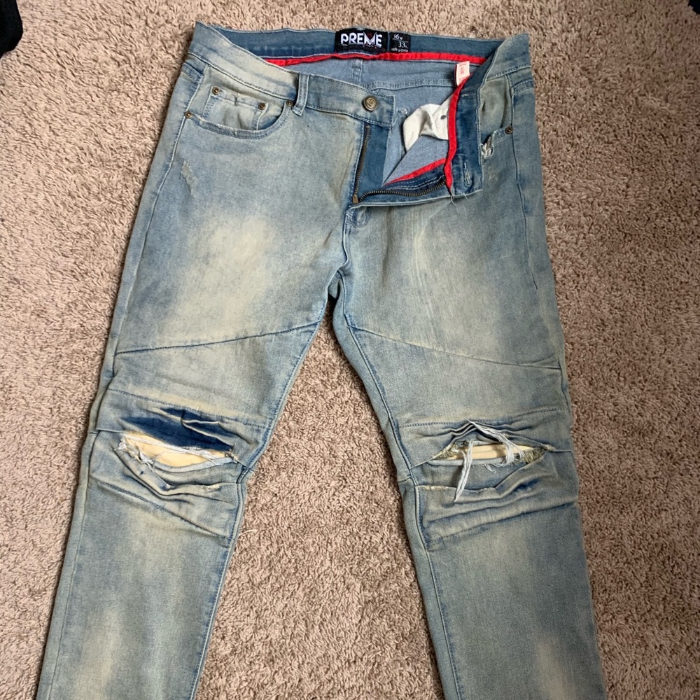 Preme paneled distressed denim w/ knee blowouts.